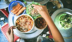 Bún Riêu served with fresh veggies and quẩy (fried dough stick)